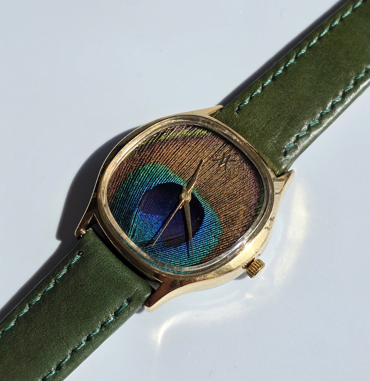 92. Peacock feather watch