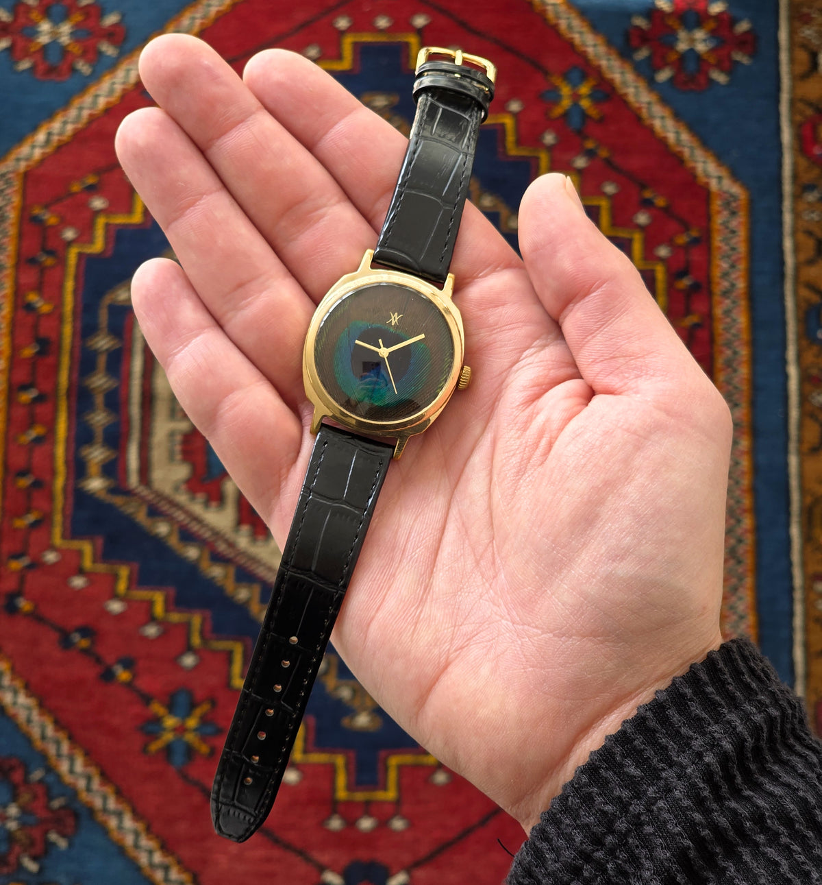 100. Peacock feather watch