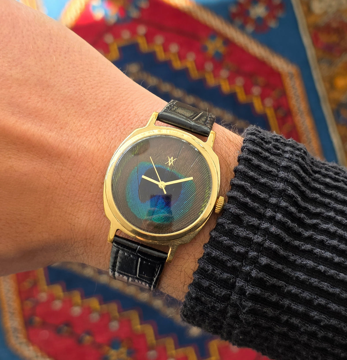 100. Peacock feather watch